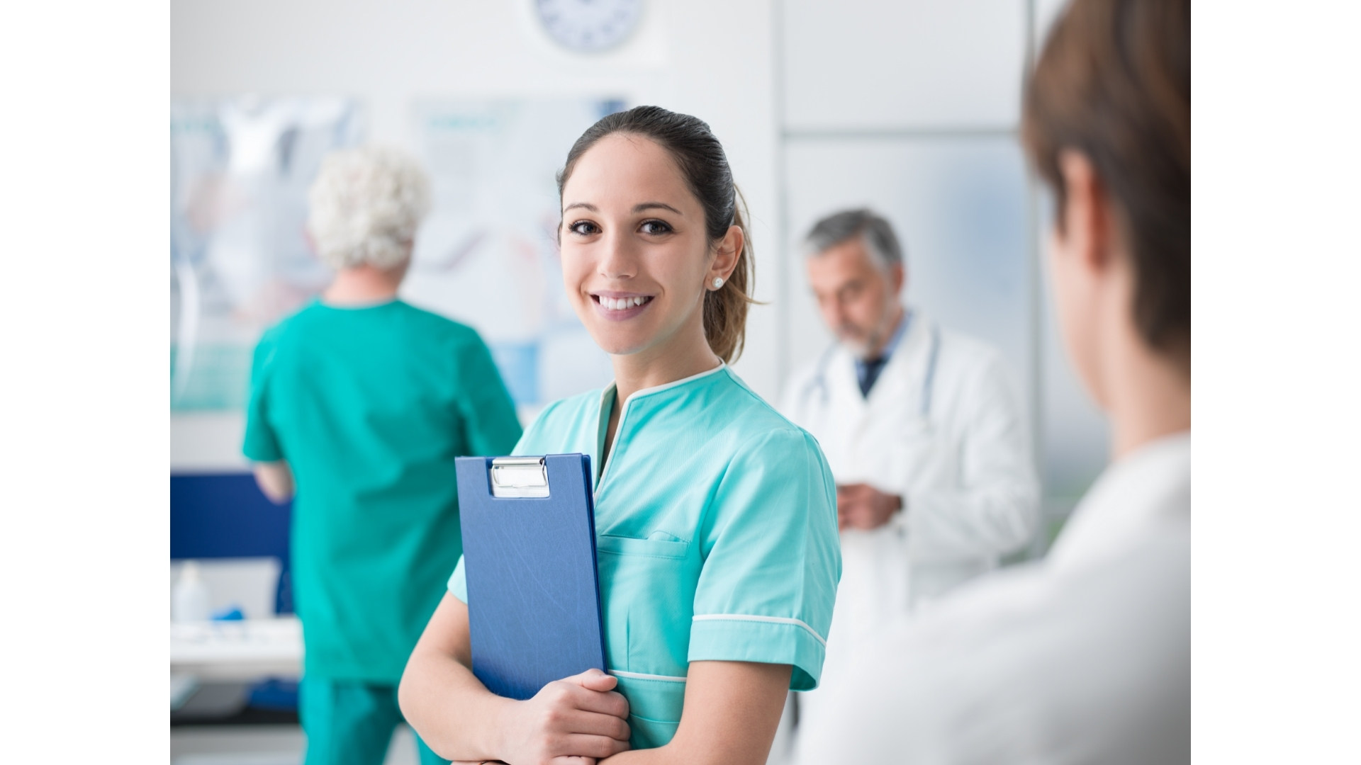 Young woman in medical scrubs holding a clipboard